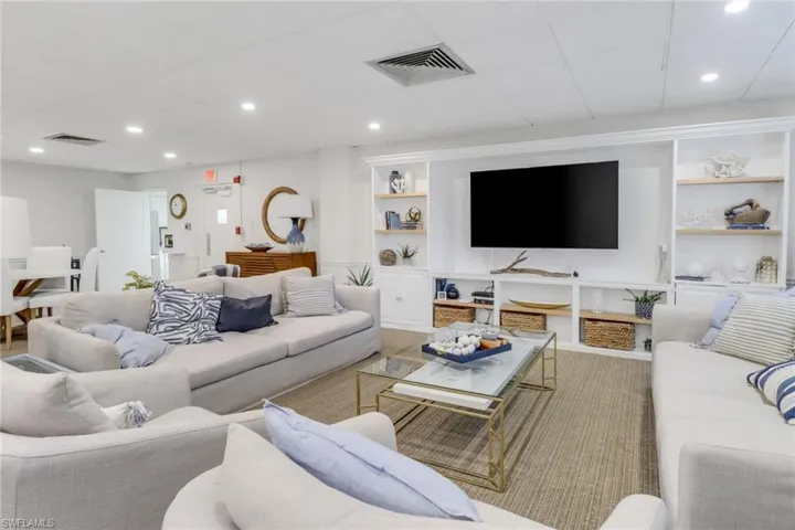 Living room with built in features and recessed lighting