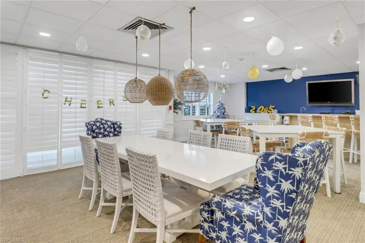 Carpeted dining space featuring recessed lighting and a drop ceiling
