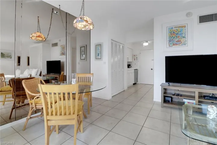 Dining area with light tile patterned floors