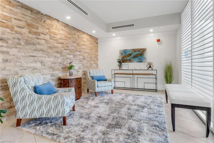 Sitting room with tile patterned floors, recessed lighting, and crown molding