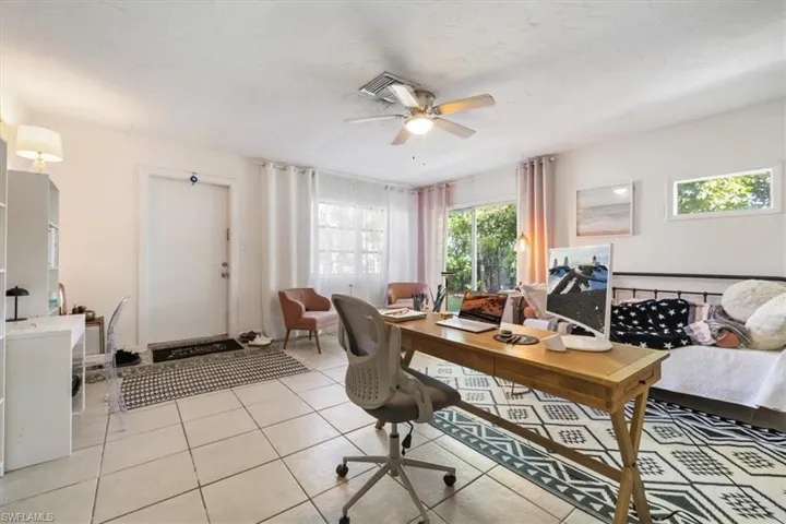 Home office featuring ceiling fan and light tile patterned flooring