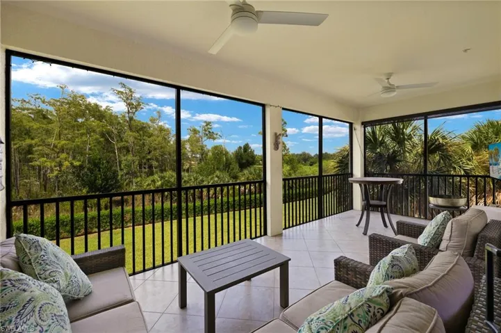 Screened lanai overlooking wooded, preserve area with side view of water