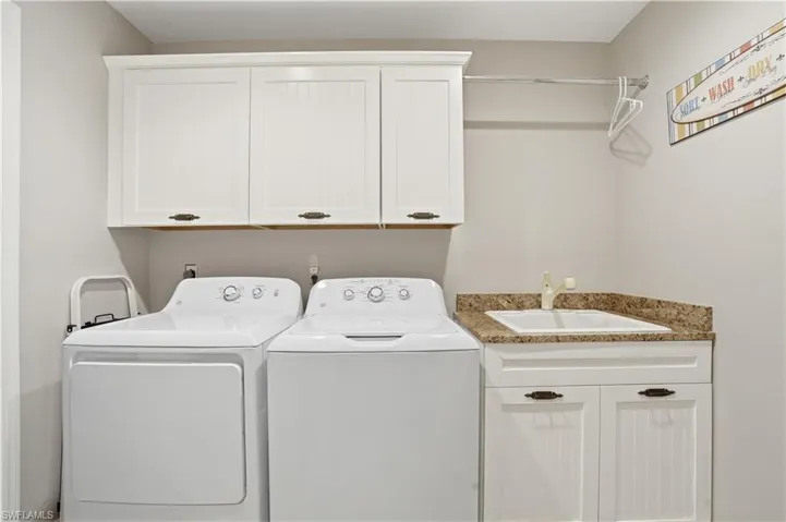 Laundry room with sink and additional cabinetry.
