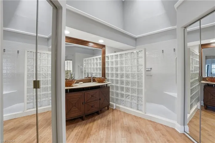 Primary bathroom features include a walk in shower and vaulted ceilings.