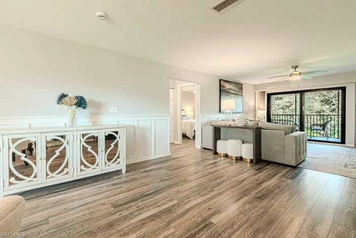 living room featuring light wood-type flooring and ceiling fan