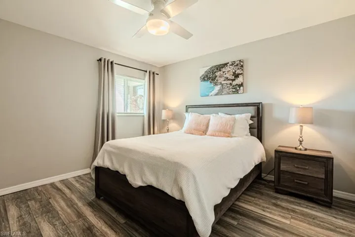 Bedroom with dark hardwood / wood-style floors and ceiling fan