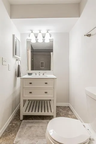 Bathroom featuring vanity, a shower with shower curtain, and toilet