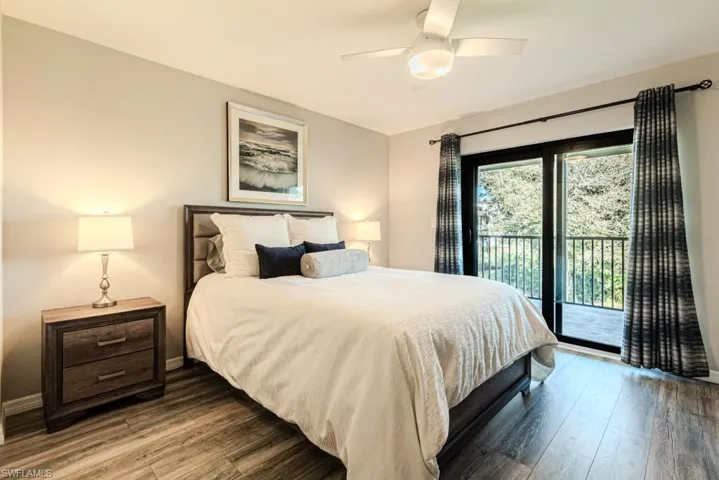 Bedroom featuring hardwood / wood-style floors, access to exterior, and ceiling fan