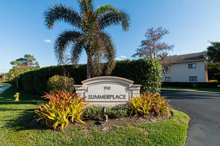 Community / neighborhood sign featuring a lawn