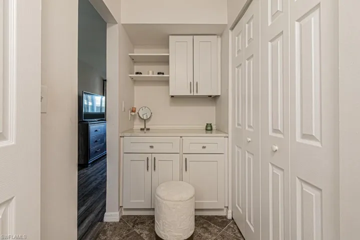 Kitchen featuring white cabinetry and dark tile patterned flooring