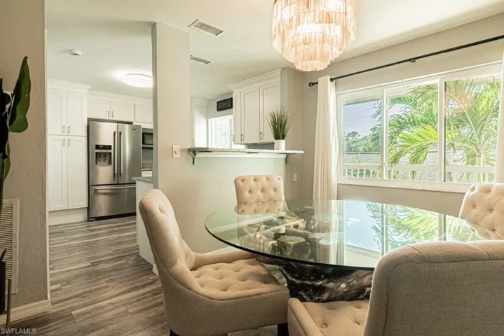 Dining room with an inviting chandelier and dark hardwood / wood-style floors