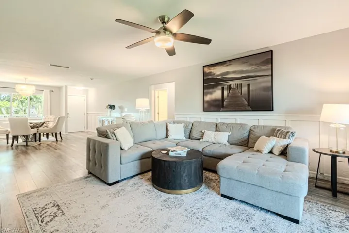 Living room with hardwood / wood-style floors and ceiling fan