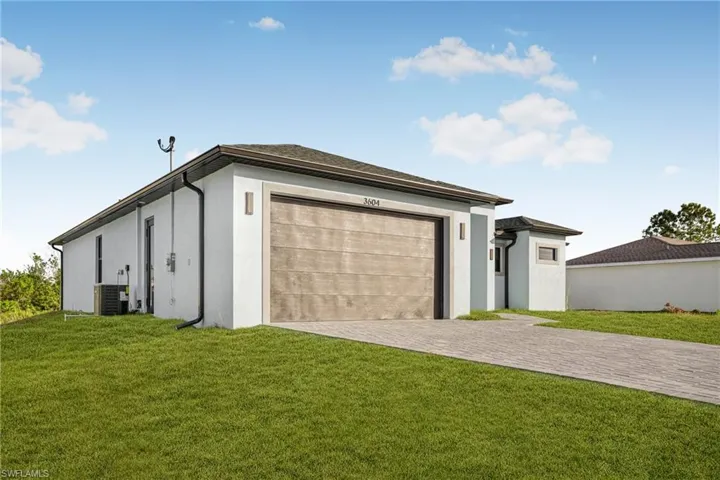 Garage featuring decorative driveway