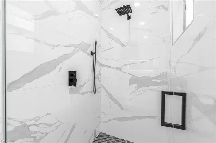 Bathroom view of a marble finish shower