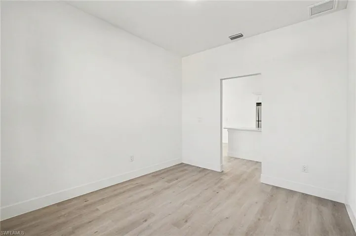 Unfurnished room featuring light wood-type flooring and baseboards