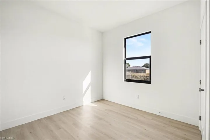 Unfurnished room featuring light wood-style floors and baseboards