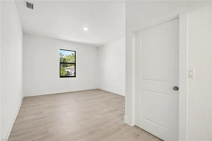 Spare room with light wood-style floors and recessed lighting