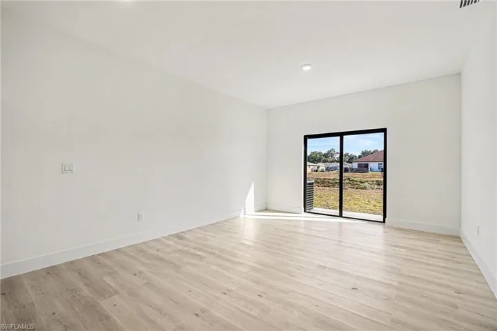 Spare room with light wood finished floors and recessed lighting