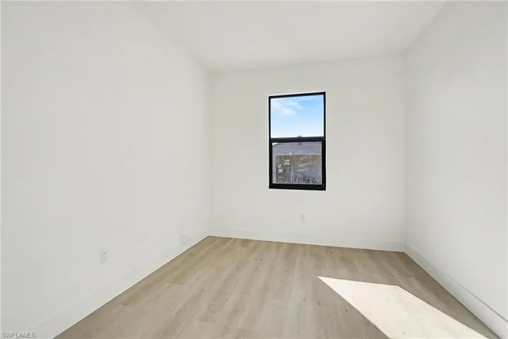 Spare room with light wood-style floors and baseboards