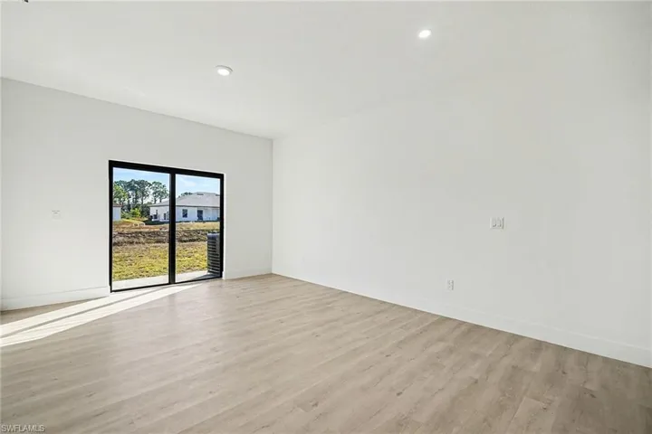 Spare room featuring light wood finished floors and recessed lighting