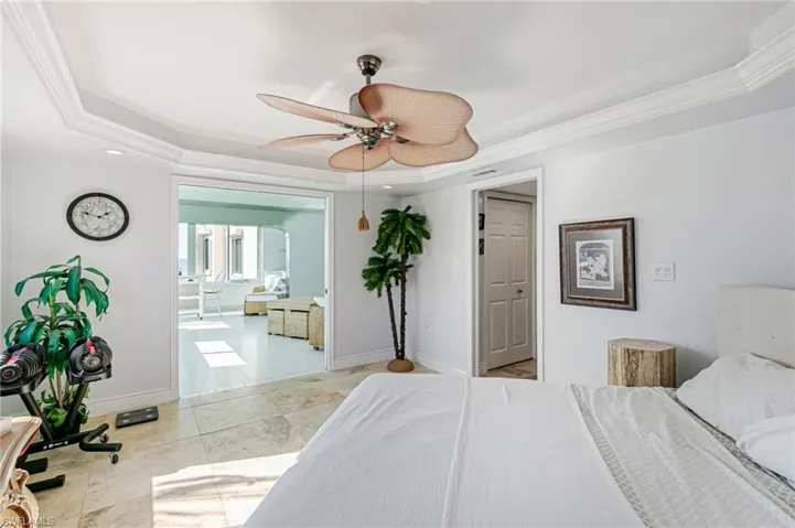 Bedroom featuring ornamental molding, a raised ceiling, recessed lighting, and ceiling fan
