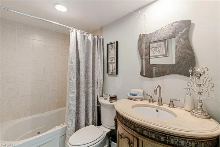 Full bathroom featuring vanity and shower / bath combination with curtain