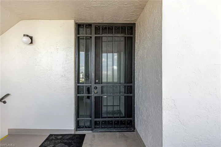 Entrance to property with stucco siding