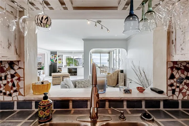 Kitchen view of backsplash, crown molding, and light countertops