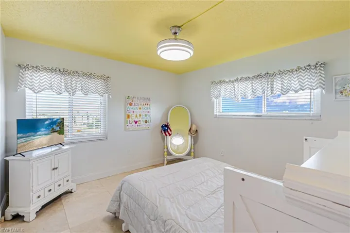 Bedroom featuring a textured ceiling and tile patterned flooring
