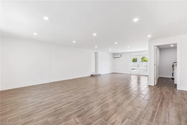 Massive bonus room with light tile floors and French doors. Newly installed mini-split. Entrance to laundry room pictured here.