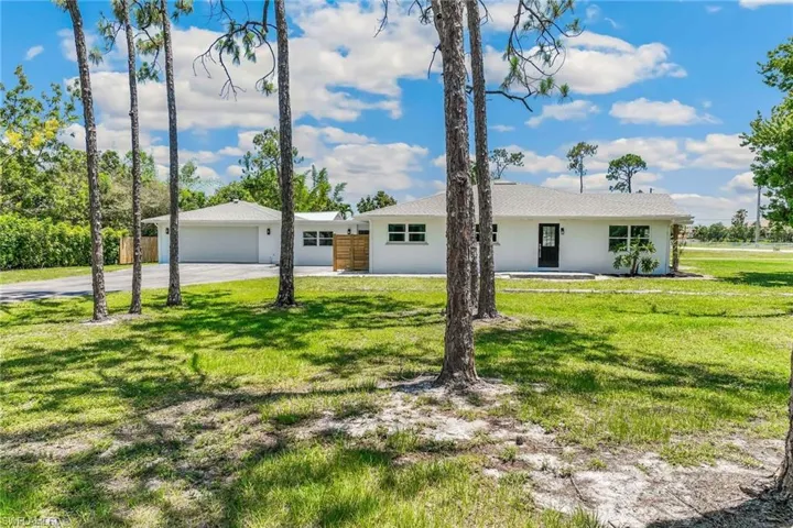 Ranch-style home with a 2 car garage and a front yard
