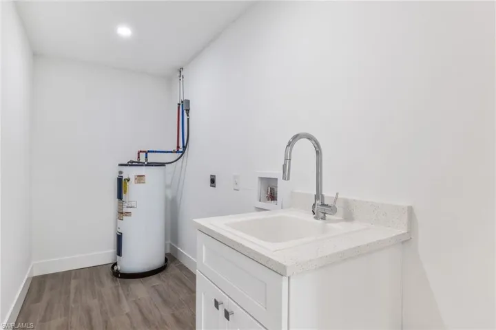 Laundry hookup, laundry tub and hot water heater.