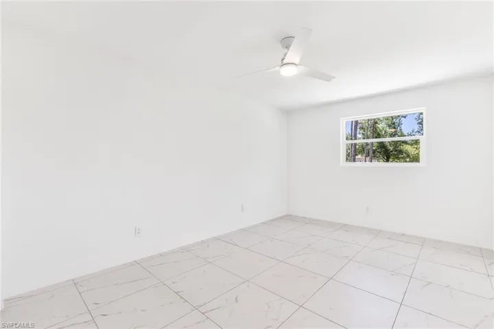 Third bedroom featuring ceiling fan and light tile floors