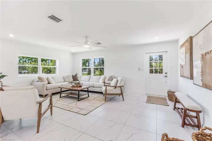 Living room featuring ceiling fan and light tile floors