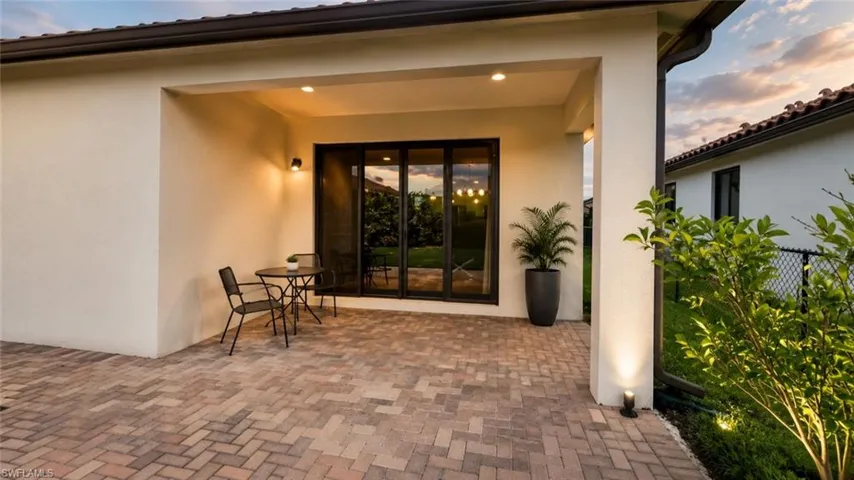 Covered patio with brick paver flooring and recessed lighting