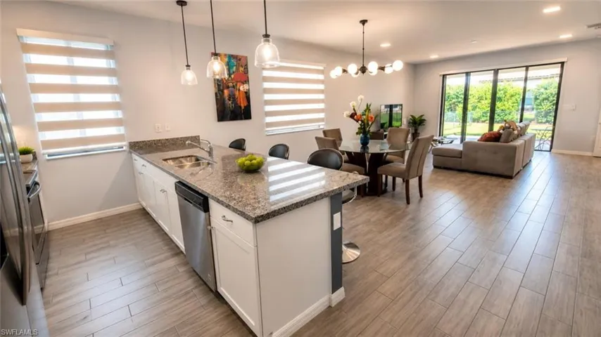 Open-concept living space with wood-finish flooring