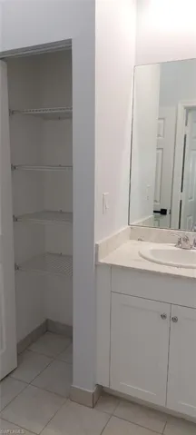 Bathroom with vanity and light tile patterned floors