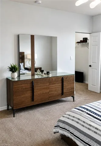 Carpeted room featuring a built-in closet with wire shelving