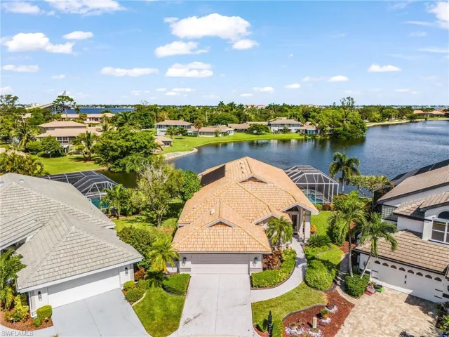 Waterfront property with mature landscaping and a screened-in pool