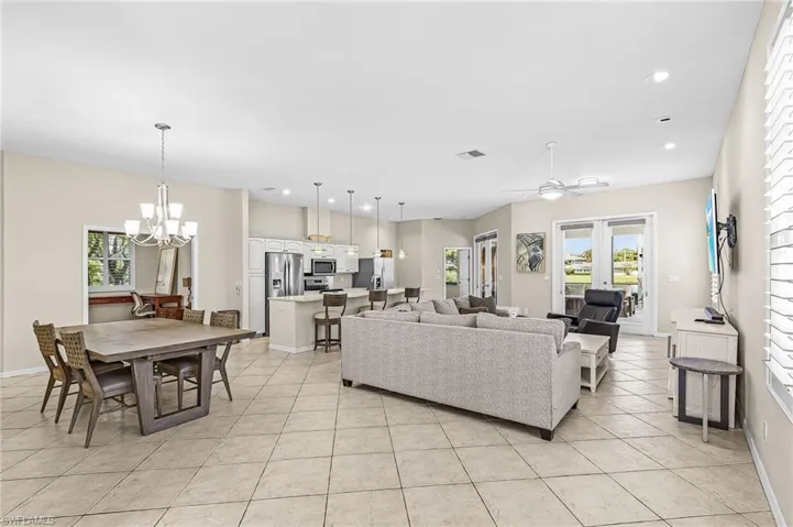 Open-concept living area with tile flooring, recessed lighting, and a ceiling fan