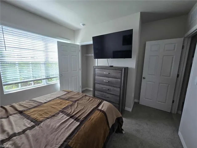 Bedroom with carpet floors and a closet