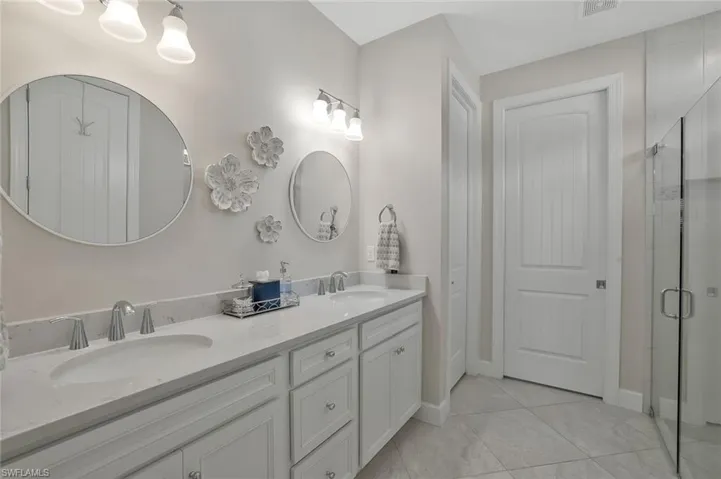 Bathroom featuring an enclosed shower and vanity