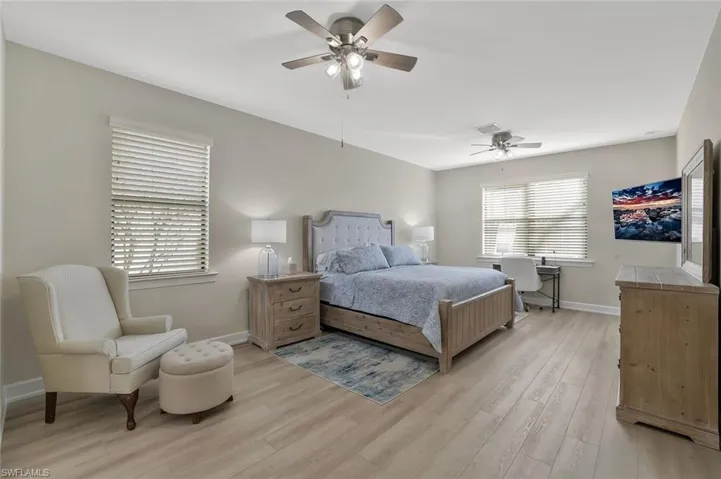 Bedroom with ceiling fan and light wood-type flooring