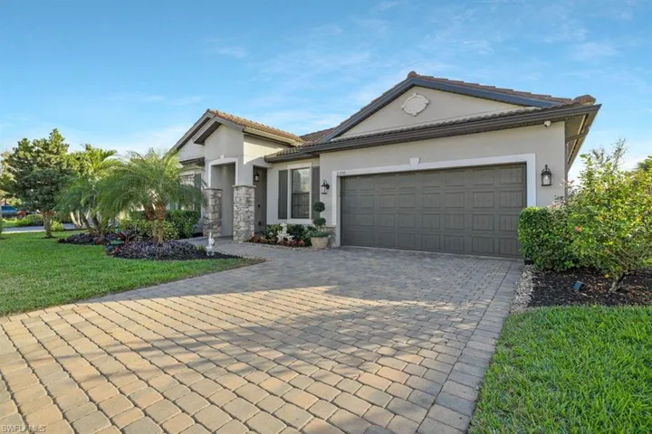 View of front of house featuring a garage and a front yard