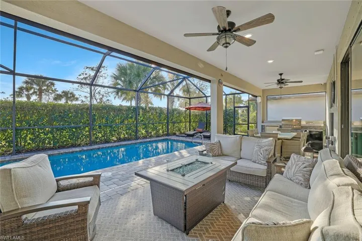 View of pool featuring area for grilling, a grill, an outdoor hangout area, and a patio