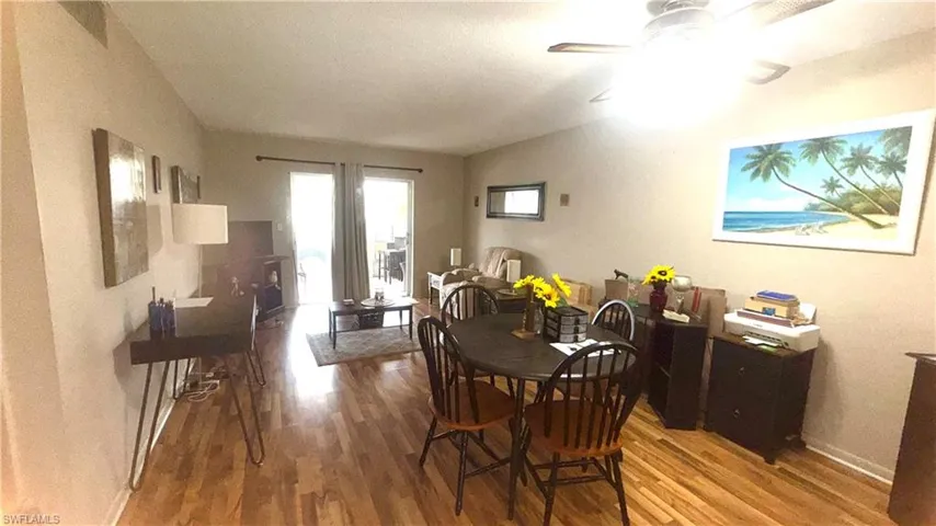 Dining area with light wood finished floors and a textured ceiling