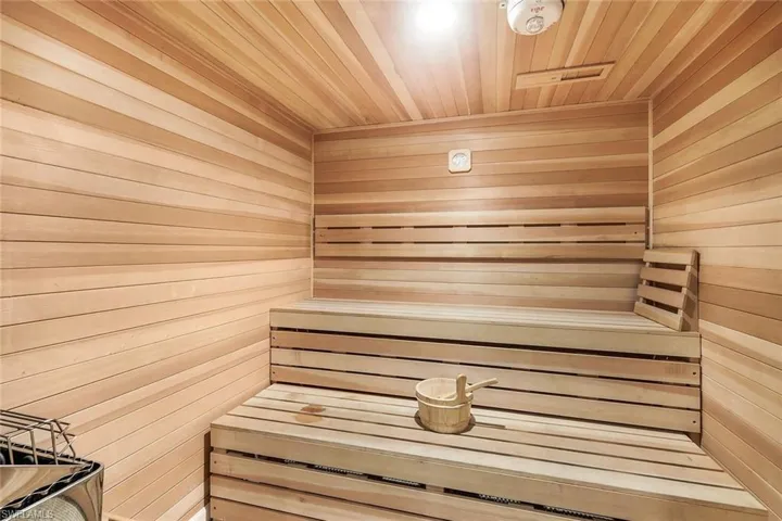View of sauna with wood ceiling and wooden walls