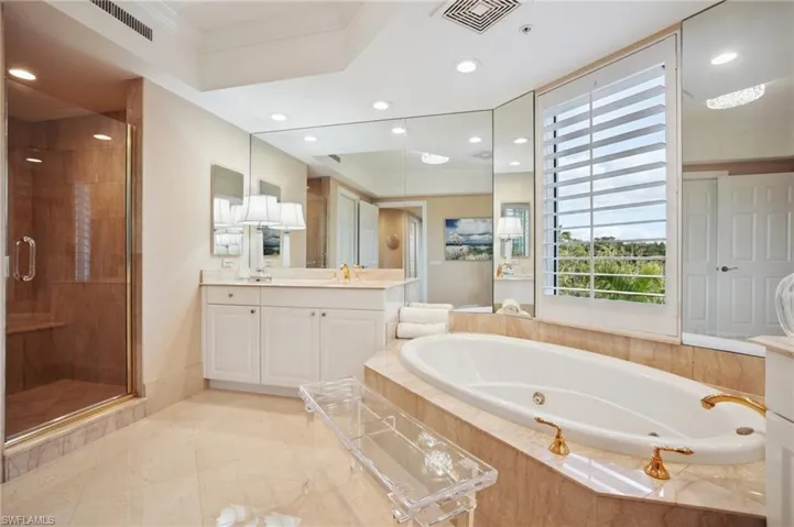 Full bath featuring a stall shower, vanity, a jetted tub, crown molding, and recessed lighting
