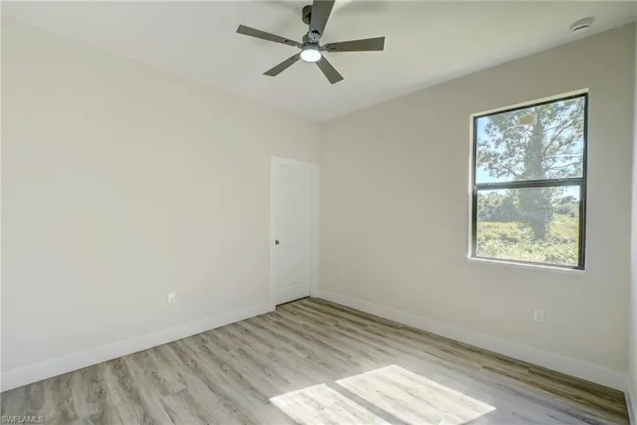 Unfurnished room with light wood-type flooring and ceiling fan