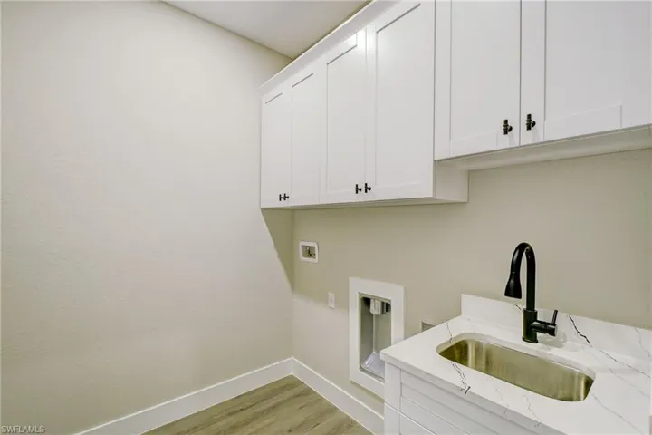 Virtual Stage - Bedroom featuring a raised ceiling, light wood finished floors, a barn door, a ceiling fan, and recessed lighting